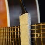 MN205_action_shot_cleaning_on_top_of_strings